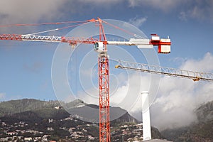 large tall crane against a madeira hill landscape