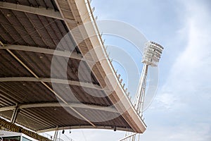large tall high outdoor stadium roof and spotlights on rigid frame construction