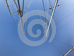 Large tall masts, a vertically standing structure on a ship, a ship supported by braces, guys, a part of sailing equipment on yach