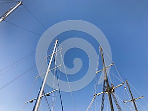 Large tall masts, a vertically standing structure on a ship, a ship supported by braces, guys, a part of sailing equipment on yach