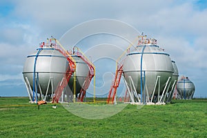 Large tank for the storage of oil and gas on a background of blue sky