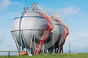 Large tank for the storage of oil and gas on a background of blue sky