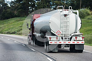 Large tanker truck hauling on highway