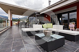 Large terrace furnished with outdoor furniture