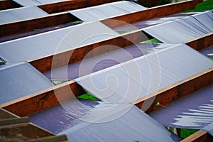 Large terrace roof with fabric panels and wooden beams for sun protection