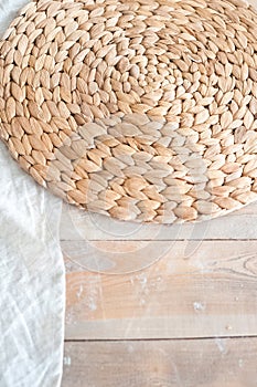 A large textured table in the ecological style and Loft style. Rustic wicker napkins, light green tablecloth, diy. White textured