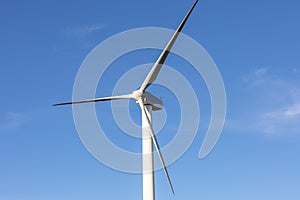 A large three blade industrial wind turbine generating electricity