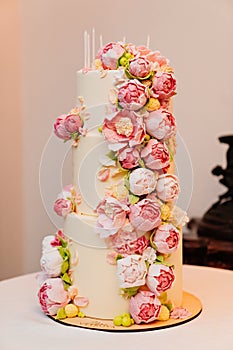 a large three-tier cake with sugar roses.