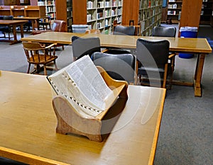Large thumb indexed dictionary in a wooden bookstand photo