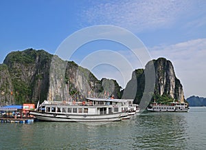 Large Tourist Junk Boats docking at Fishing Village in Halong Bay