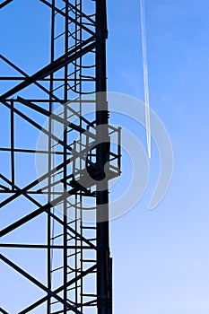 Large tower of metal structures against the blue sky. Metal construction.