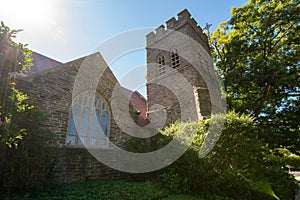 A Large Tower and Window on a Cobblestone Church