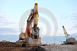 Large tracked excavator on a construction site. Road repair, asphalt replacement.  Loading of stone and rubble for its processing