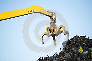 Large tracked excavator working a steel pile
