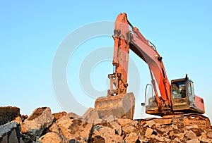 Large tracked excavator works in a gravel pit.