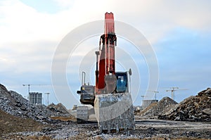 Large tracked excavator works in a gravel pit. Salvaging and recycling building and construction materials.