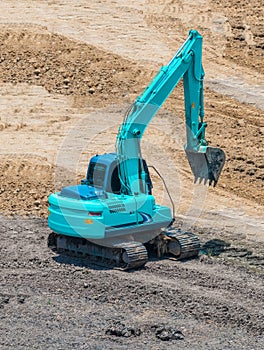 A large trackhoe moving rock