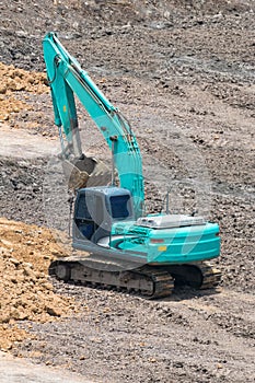 A large trackhoe moving rock