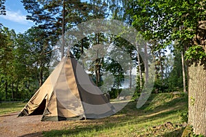 A large traditional teepee tent with luxurious glamping interior provides alternate but comfortable lodging for outdoor adventurer