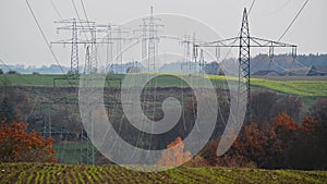 Large transmission towers in the countryside. Different types of electricity pylons in the countryside. Large electricity poles in