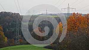 Large transmission towers in the countryside. Different types of electricity pylons in the countryside. Large electricity poles in