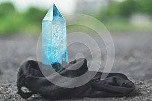 Large transparent mystical faceted crystal of colored blue sapphire, topaz on a light background close-up Wonderful mineral quartz