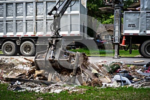 Large truck picking up trash and debris outside of Houston neighborhood