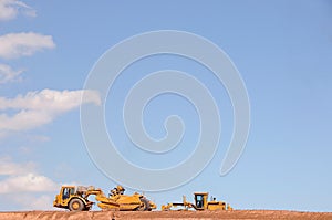 Large trucks moving dirt