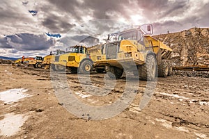 Large trucks in an open pit mine