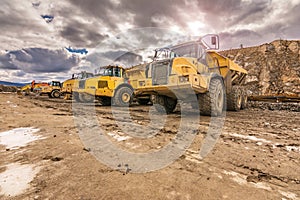 Large trucks in an open pit mine