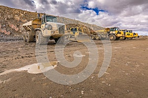 Large trucks in an open pit mine