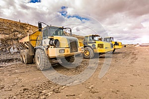 Large trucks in an open pit mine