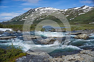 Large turquoise River landscape and mountainous valley in Padjelanta