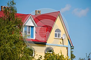 Large two-storey beautiful country house with red tiles, plastic windows and satellite dish