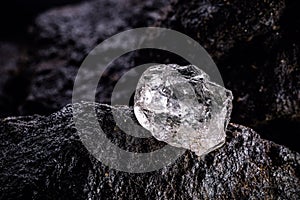 large uncut diamond stone in a natural state within a mine. Concept of beauty  luxury and rare jewel photo