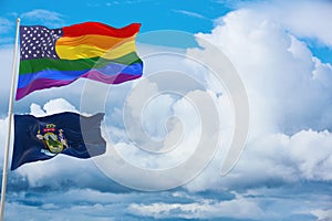 large US lgbtqflag and flag of Maine state, USA waving in wind at cloudy sky. Freedom and love concept. Pride month. activism, photo