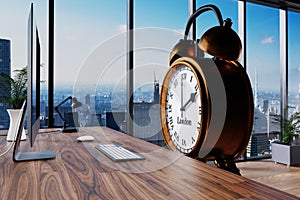Large vintage personified alarm clock sitting in front of workplace with skyline view; conceptual overwork stress working hours;