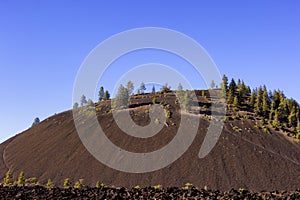 Large volcanic cinder cone seen from highway 97 in eastern Oregon, USA