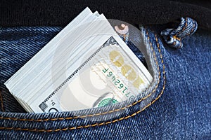 large wad of hundred-dollar bills protrudes from pocket of jeans. Concept of cash bribery. All money earned is all given for