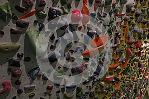 Large wall full of grips to climb up during a bouldering session