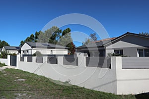 Large wall house building in street with neighbour