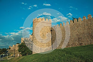 Large wall with towers over hilly landscape at Avila