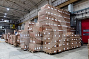 large warehouse with cardboard boxes, blurred photo