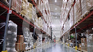 Large warehouse, factory, boxes, shelf. Machine work and vehicle delivering