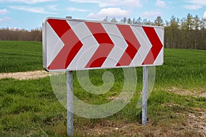 A large warning sign for a very sharp bend on a German country road