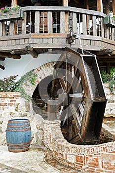 Large water mill and wooden barrel