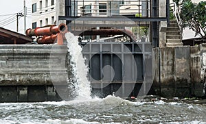 Large water pipe discharging liquid waste into river