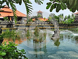 Large water pond with fountains in front of the balinese resourt in Nusa Dua in Indonesia