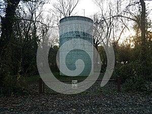 large water tower or storage tank with no parking sign