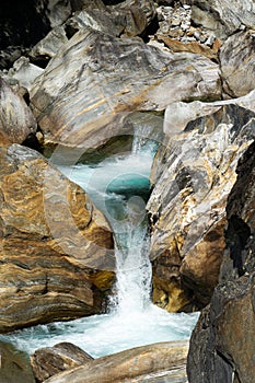 A large waterfall over a rocky cliff at Verzasca valley in Siwtzerland